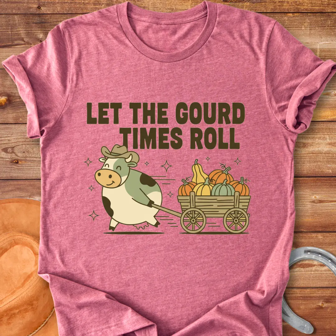Cow pulling a wagon full of pumpkins with the text 'Let the Gourd Times Roll' – a fall-themed t-shirt design from Cow Lovers Clothing.