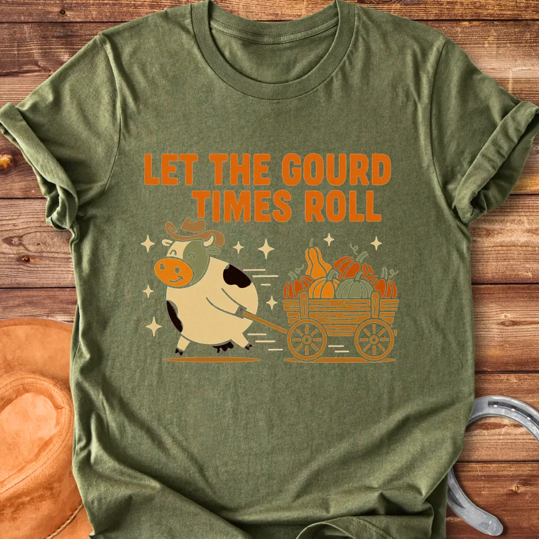 Cow pulling a wagon full of pumpkins with the text 'Let the Gourd Times Roll' – a fall-themed t-shirt design from Cow Lovers Clothing.