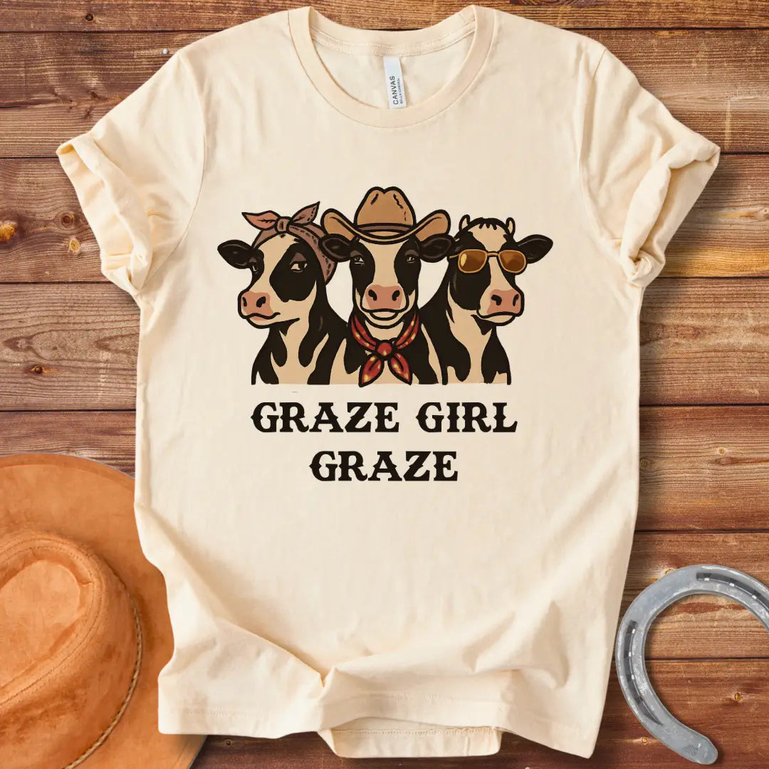 Graze Girl Graze T-Shirt featuring a trio of stylish cows wearing a bandana, a cowboy hat, and sunglasses.
