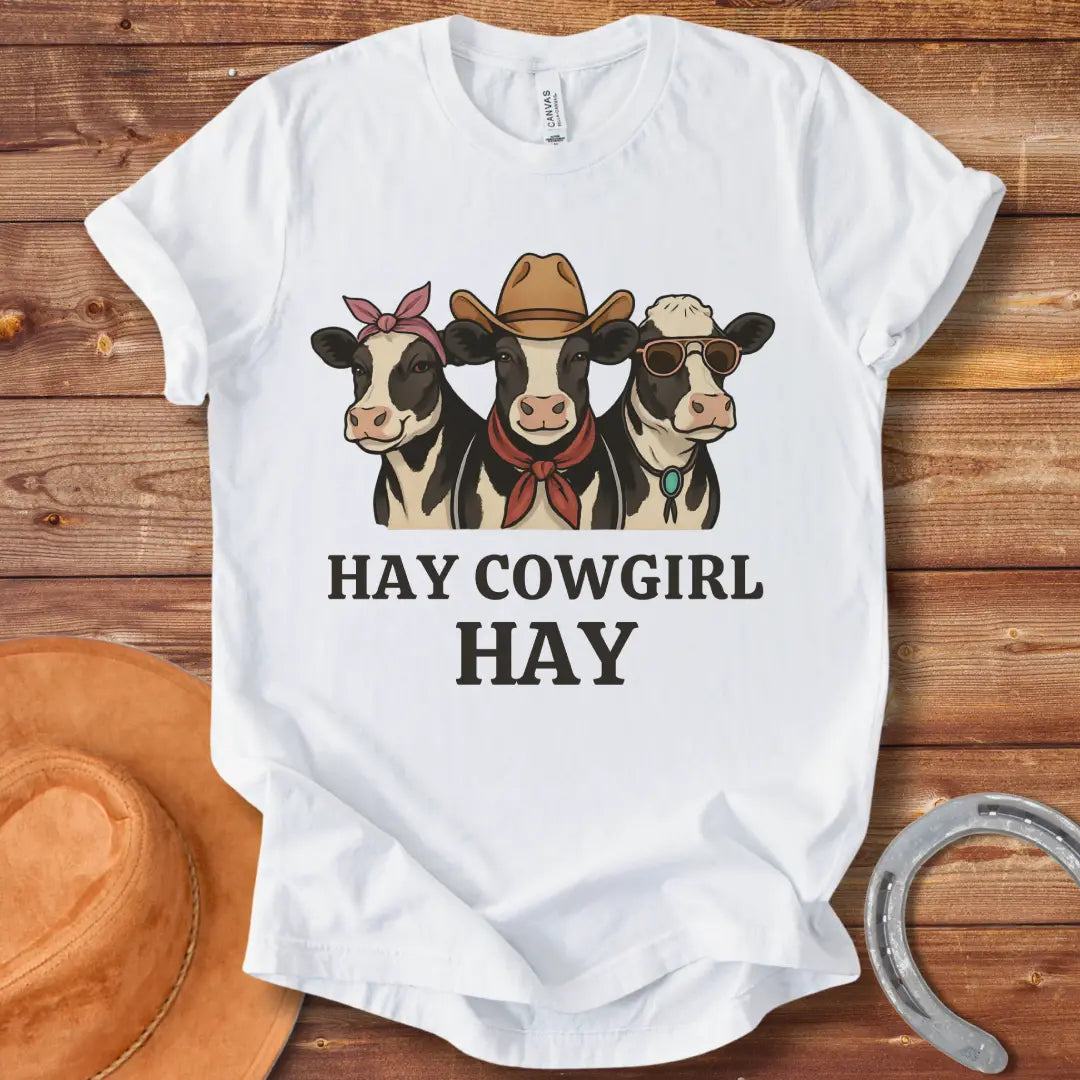 Three cartoon cows, one with a bandana, one with a cowboy hat and scarf, and one with sunglasses, with the text 'Hay Cow Girl Hay' below.