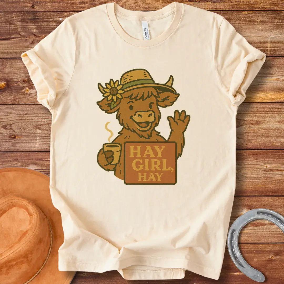 Illustration of a friendly cow wearing a hat with a sunflower, holding a mug and sign that reads 'Hay Girl, Hay'.