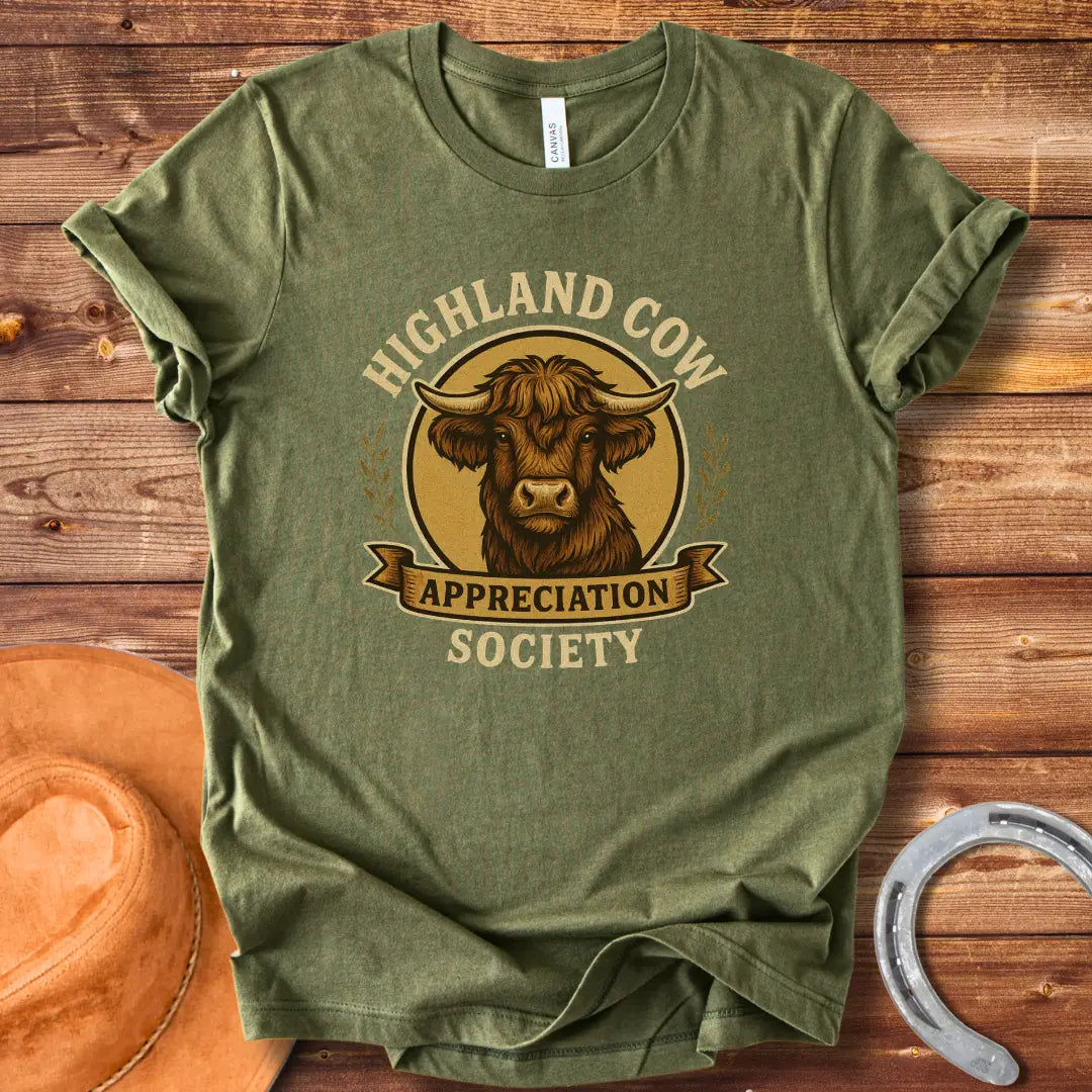 Highland Cow Appreciation Society T-Shirt featuring a detailed drawing of a highland cow with the words 'Highland Cow Appreciation Society' in a circular design.
