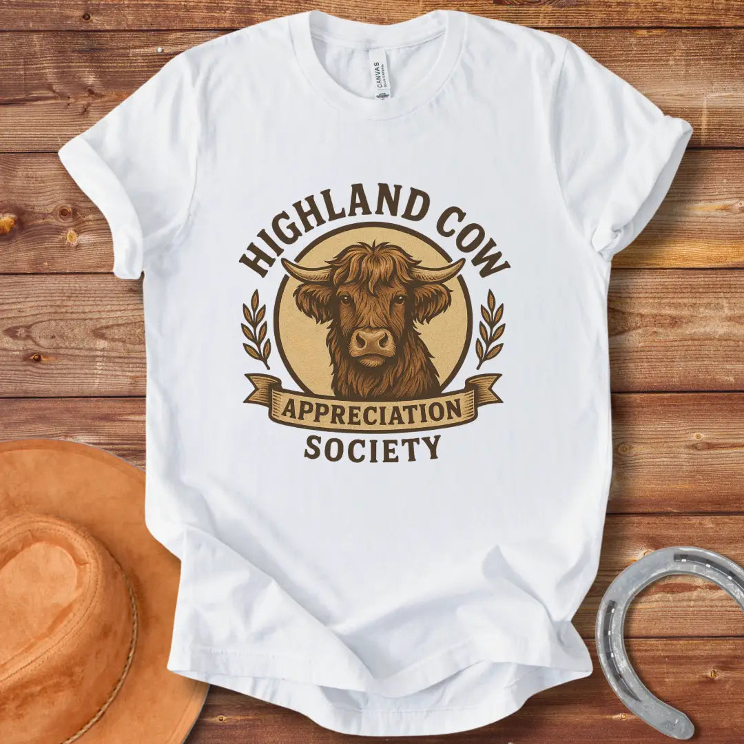 Highland Cow Appreciation Society T-Shirt featuring a detailed drawing of a highland cow with the words 'Highland Cow Appreciation Society' in a circular design.