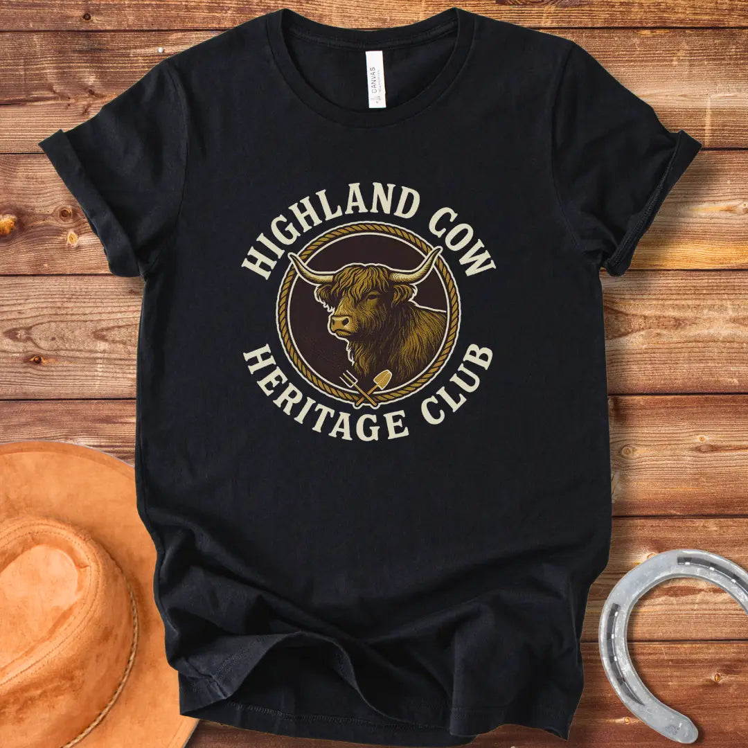 Highland Cow Heritage Club T-Shirt featuring a detailed illustration of a Highland cow with a rope circle and farm tools.