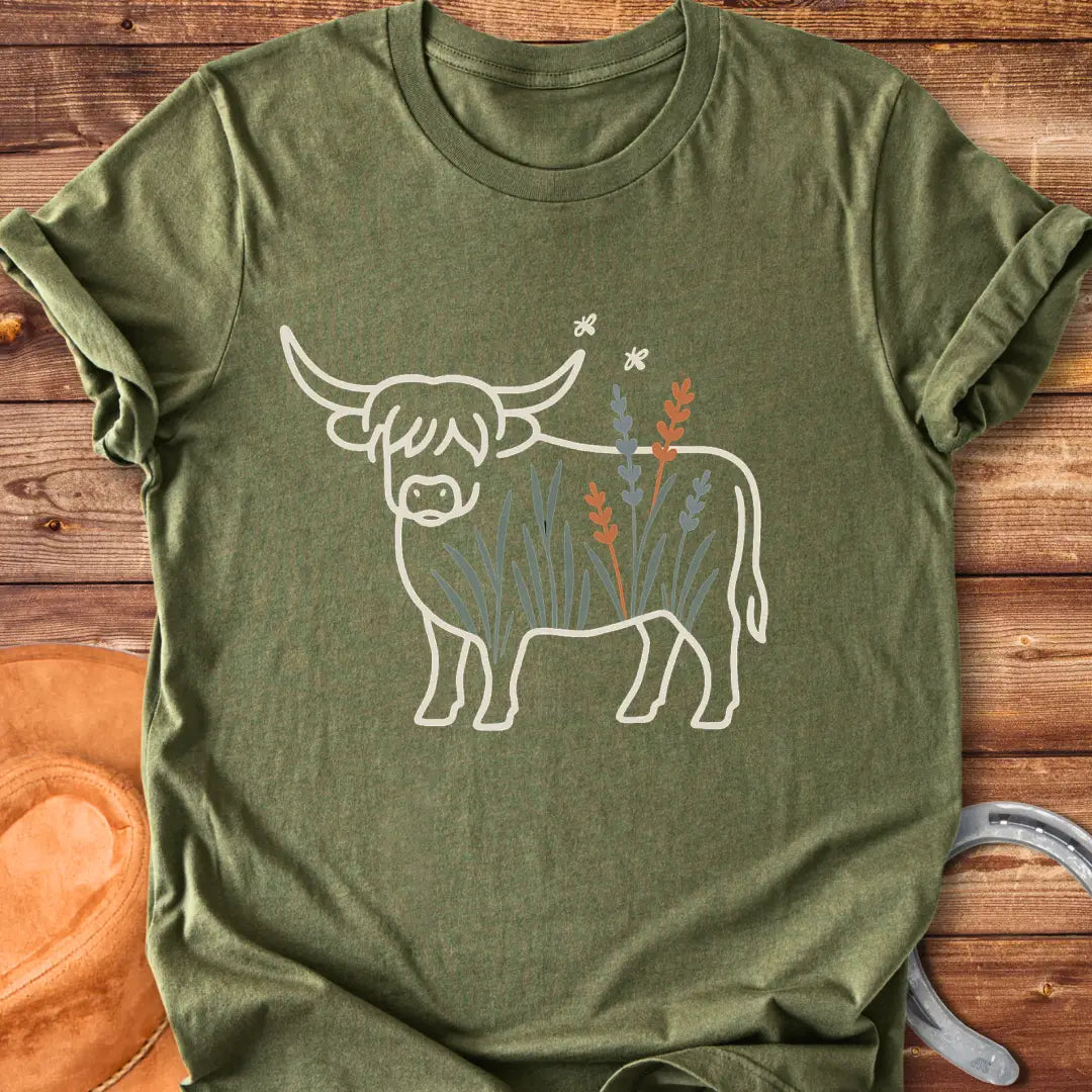 Line drawing of a Highland cow with floral accents on a black background.