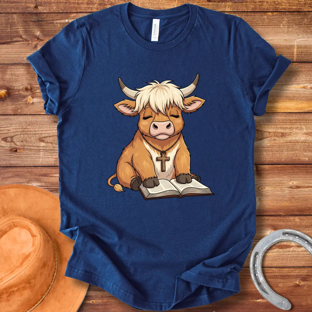 Cartoon illustration of a cow wearing a cross necklace, sitting peacefully with a book open in its lap.