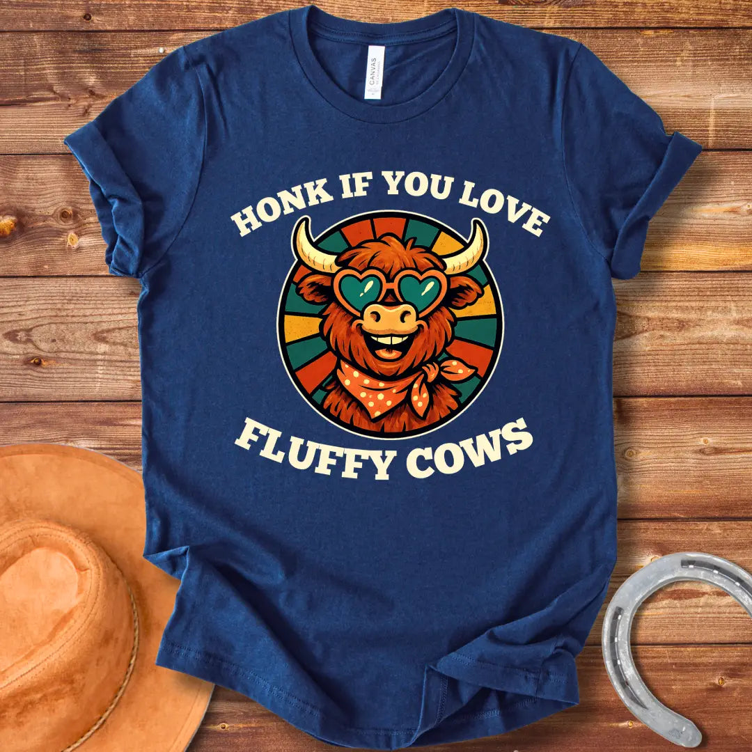 T-shirt design with a smiling cow wearing heart-shaped sunglasses and a bandana, with the text 'Honk If You Love Fluffy Cows'.