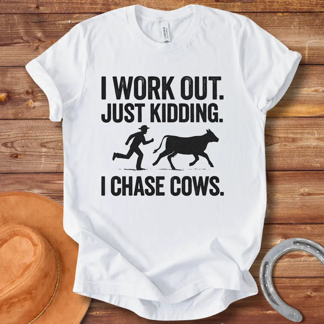 Vintage T-shirt with a humorous design of a person chasing a cow, with the words 'I Work Out. Just Kidding. I Chase Cows.'