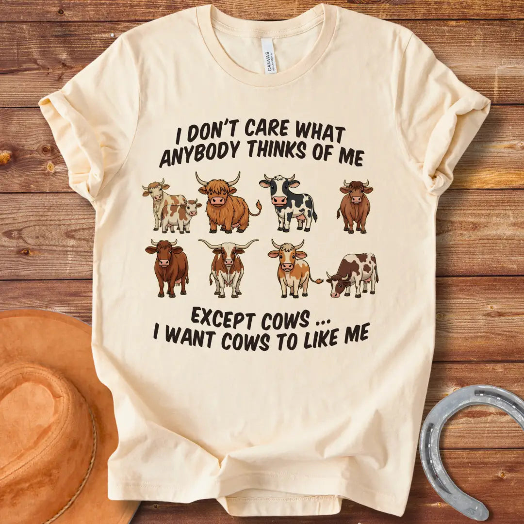 T-shirt design featuring multiple cartoon cow breeds with the phrase 'I Don't Care About Anybody Except Cows' on a black background.