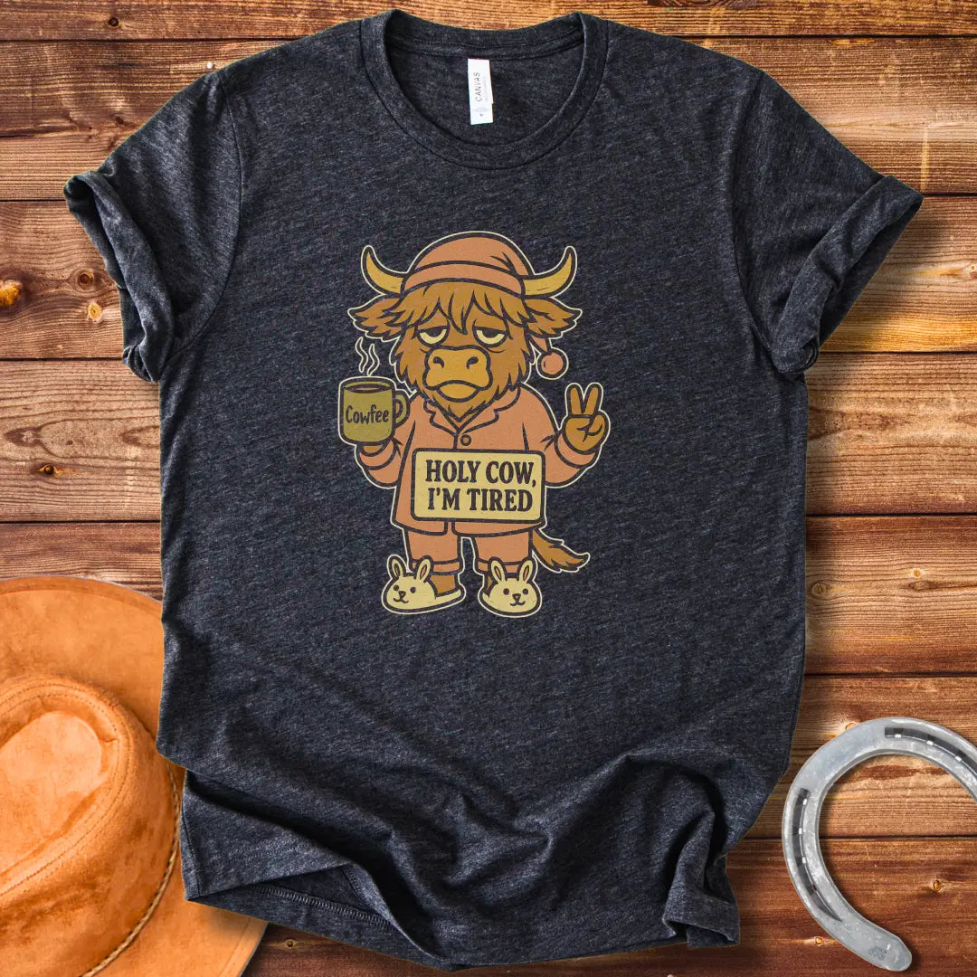 Illustration of a tired cow in pajamas holding a coffee mug that says 'Cowfee,' holding up a peace sign, and wearing bunny slippers. Text on the cow's sign reads 'Holy Cow, I'm Tired.'