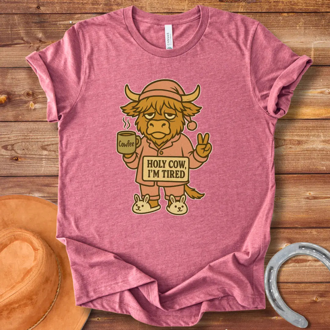 Illustration of a tired cow in pajamas holding a coffee mug that says 'Cowfee,' holding up a peace sign, and wearing bunny slippers. Text on the cow's sign reads 'Holy Cow, I'm Tired.'