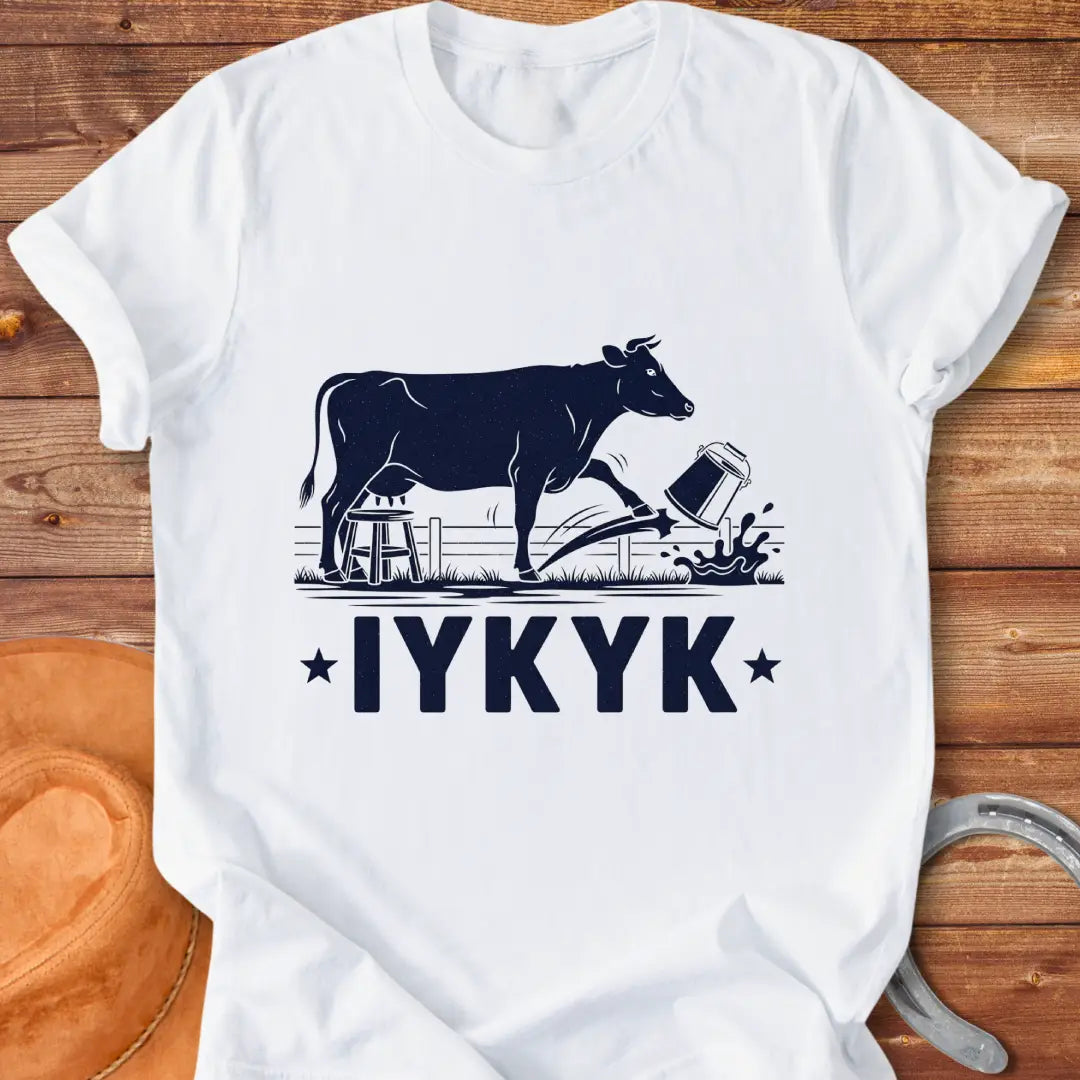 Illustration of a cow kicking a bucket, with the words 'IYKYK' and a farm scene background.