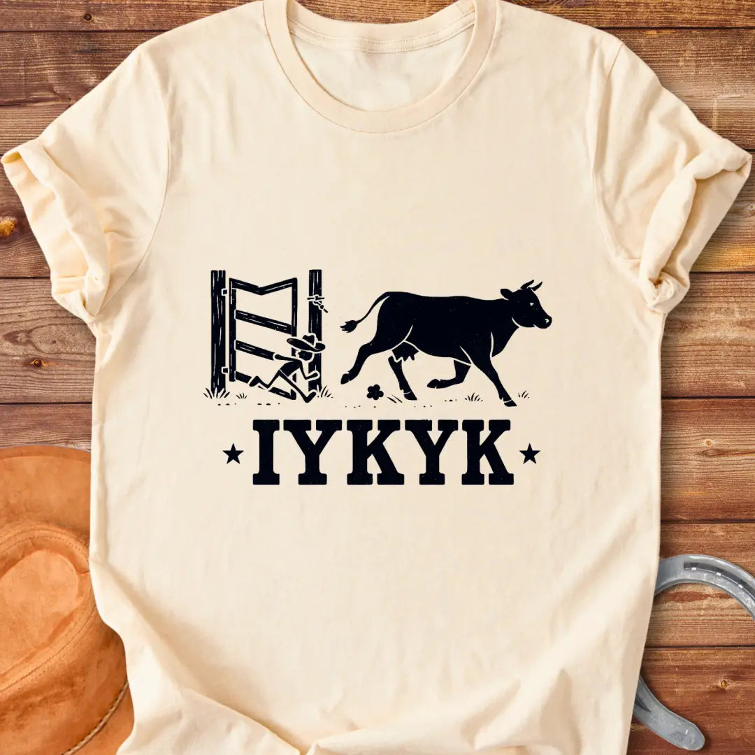 Silhouette of a cow running through an open gate with IYKYK text below.