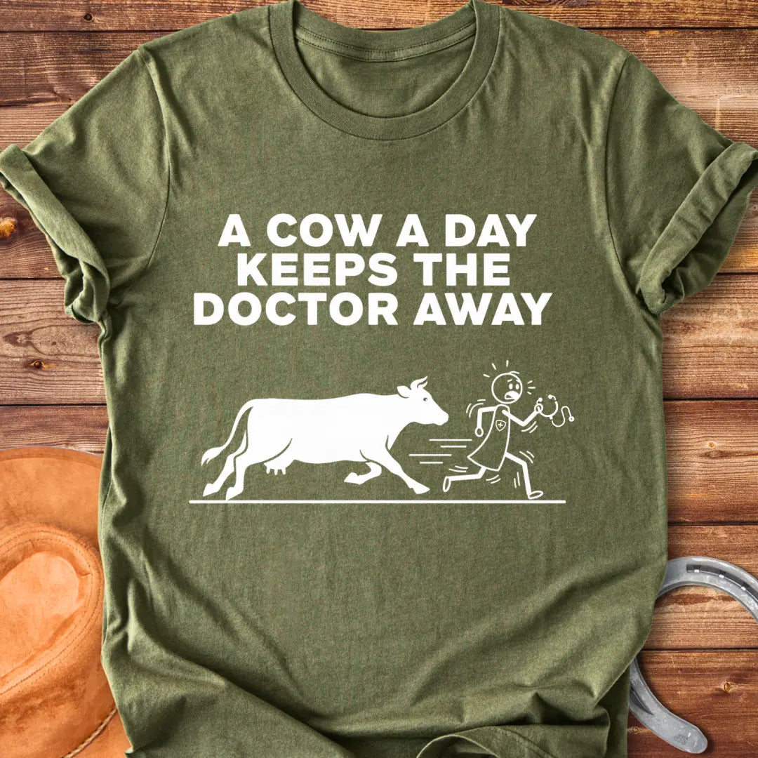 Black t-shirt design with a cow illustration and the text 'A Cow a Day Keeps the Doctor Away'