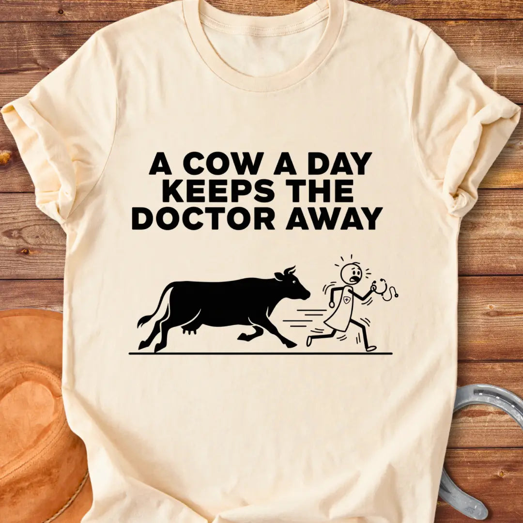 Black t-shirt design with a cow illustration and the text 'A Cow a Day Keeps the Doctor Away'