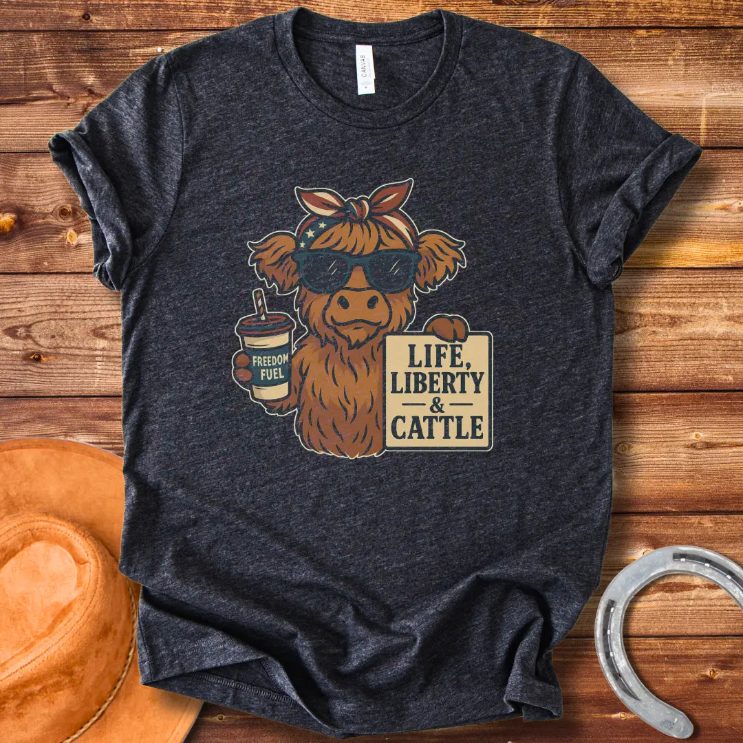 A Highland cow wearing sunglasses and a bandana, holding a sign that says 'Life, Liberty & Cattle' and a cup that says 'Freedom Fuel'.