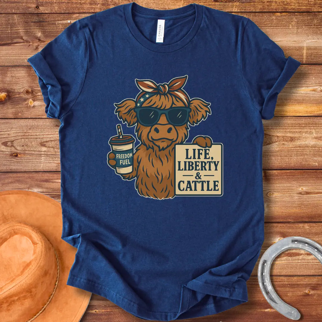 A Highland cow wearing sunglasses and a bandana, holding a sign that says 'Life, Liberty & Cattle' and a cup that says 'Freedom Fuel'.