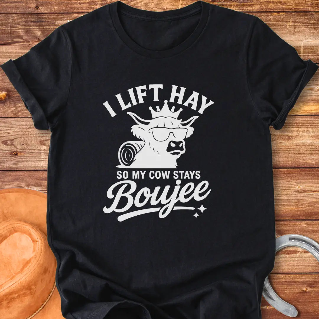 A Highland cow wearing sunglasses and a crown, the text saying 'I lift hay so my cow stays boujee'