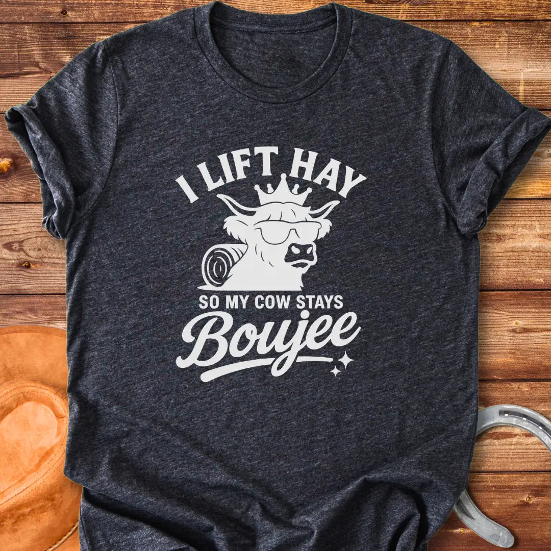 A Highland cow wearing sunglasses and a crown, the text saying 'I lift hay so my cow stays boujee'