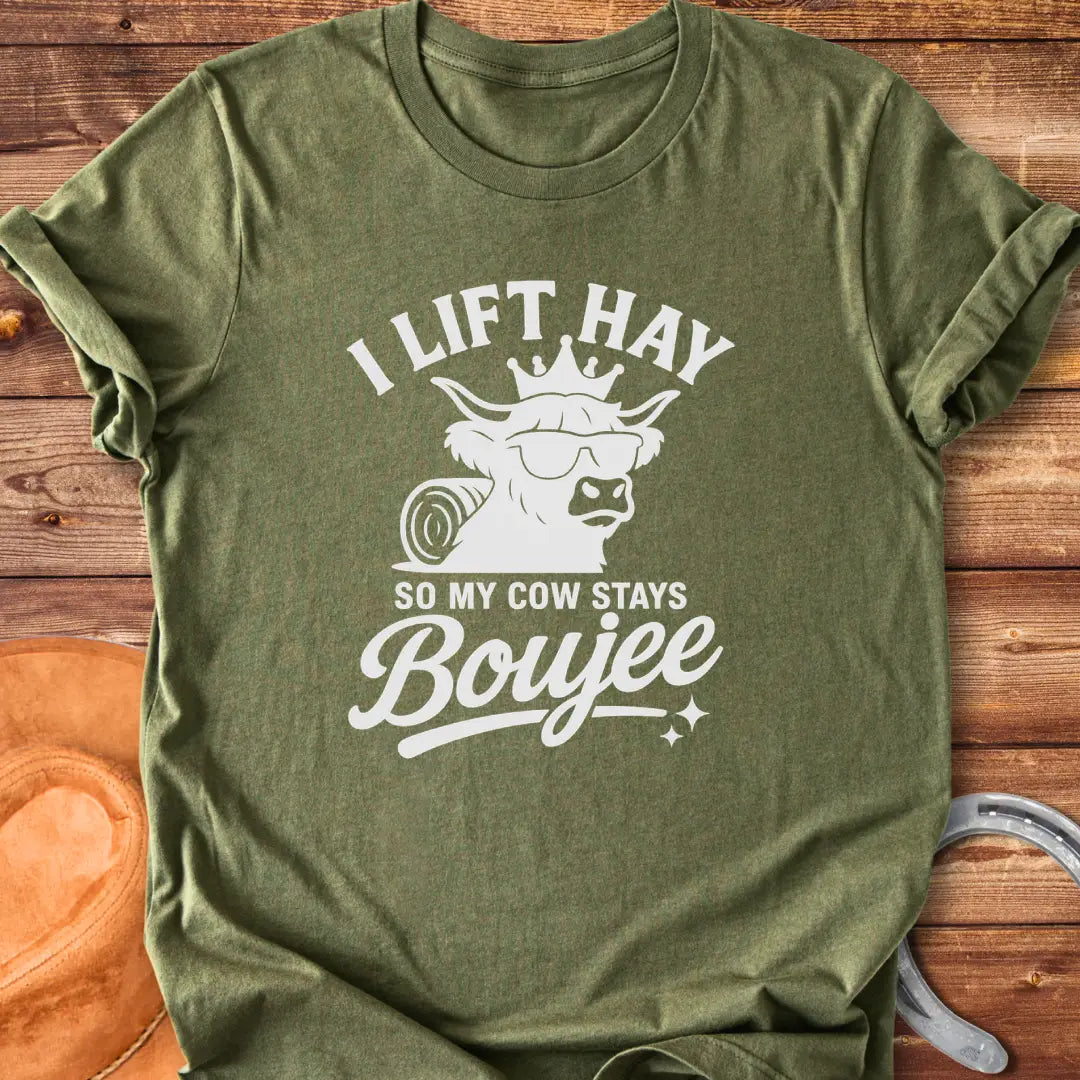A Highland cow wearing sunglasses and a crown, the text saying 'I lift hay so my cow stays boujee'