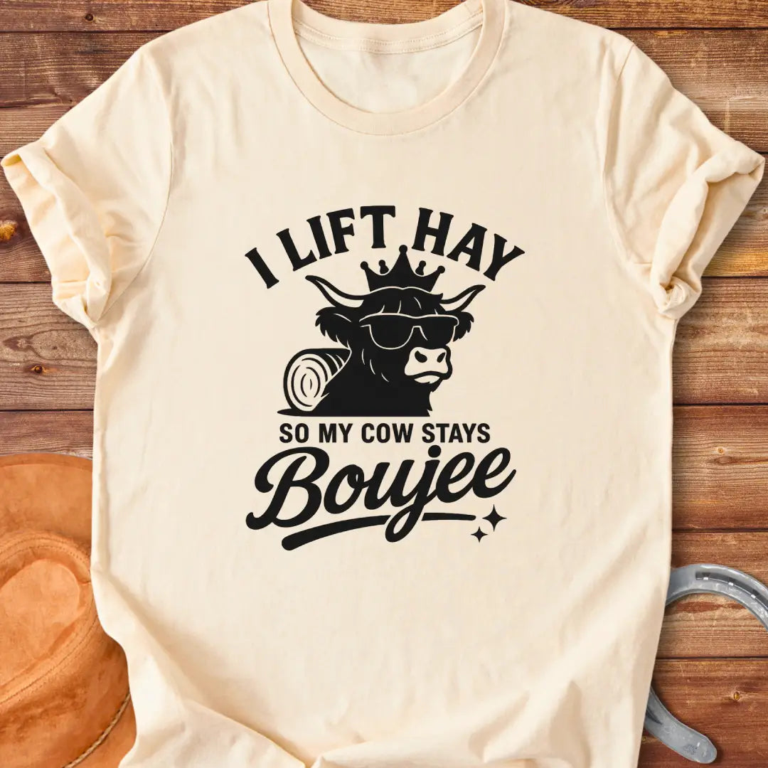 A Highland cow wearing sunglasses and a crown, the text saying 'I lift hay so my cow stays boujee'