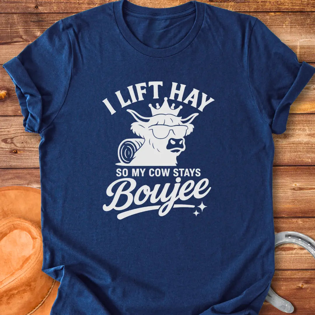 A Highland cow wearing sunglasses and a crown, the text saying 'I lift hay so my cow stays boujee'