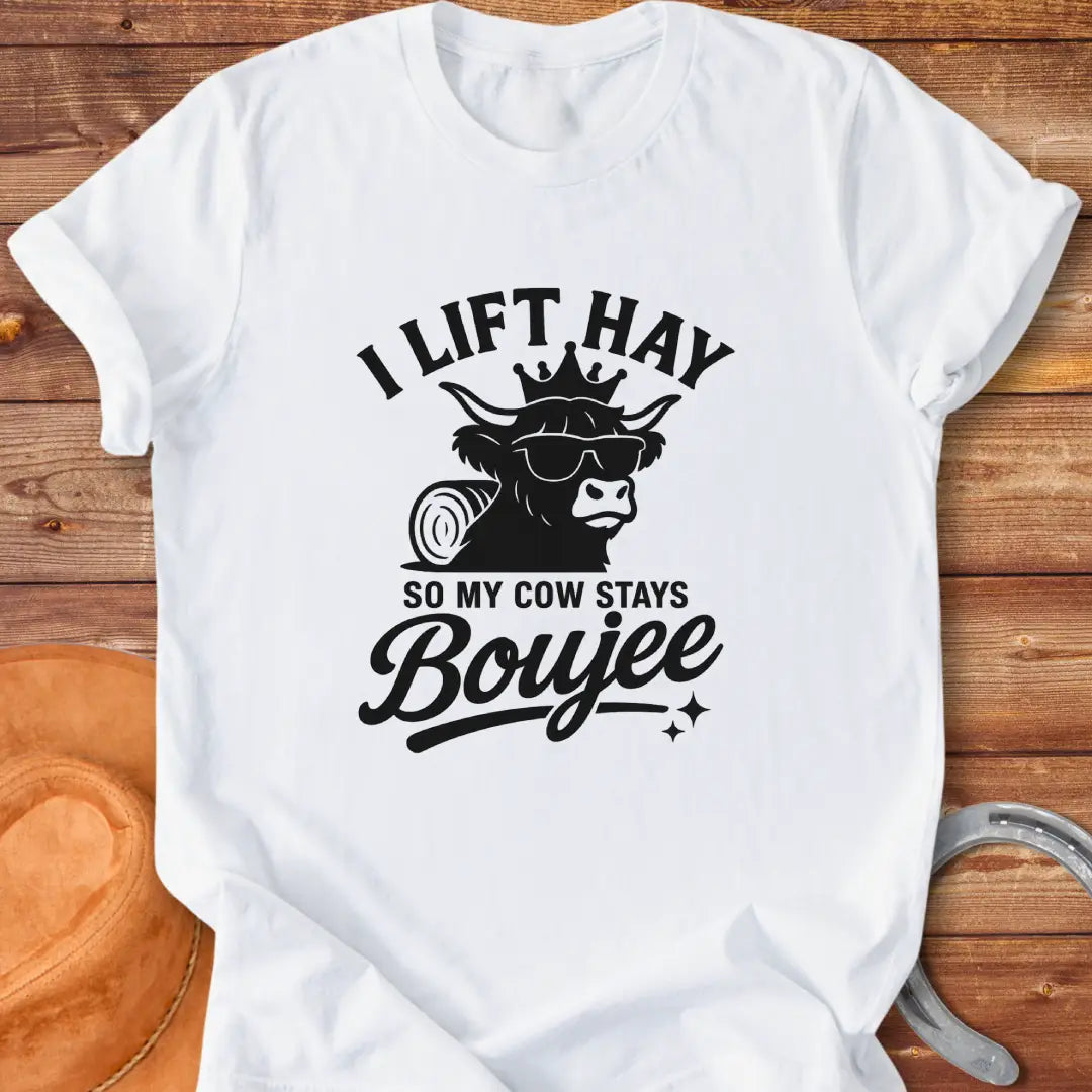 A Highland cow wearing sunglasses and a crown, the text saying 'I lift hay so my cow stays boujee'