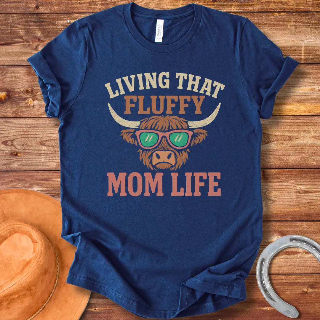 A graphic of a Highland cow wearing sunglasses with the text 'Living That Fluffy Mom Life' above and below it.