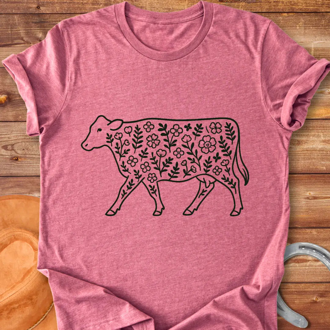 Black and white illustration of a cow with floral design inside.