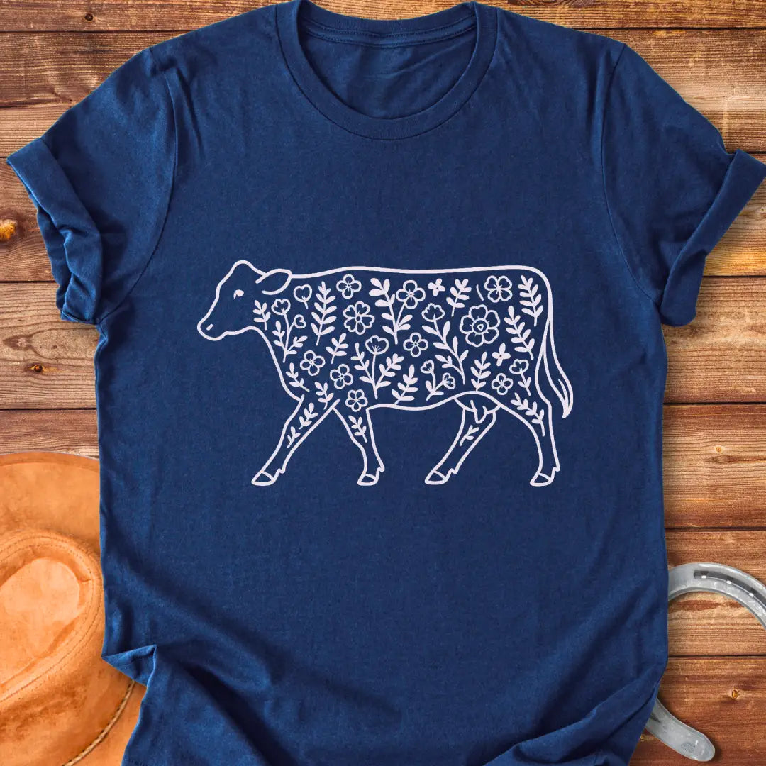 Black and white illustration of a cow with floral design inside.