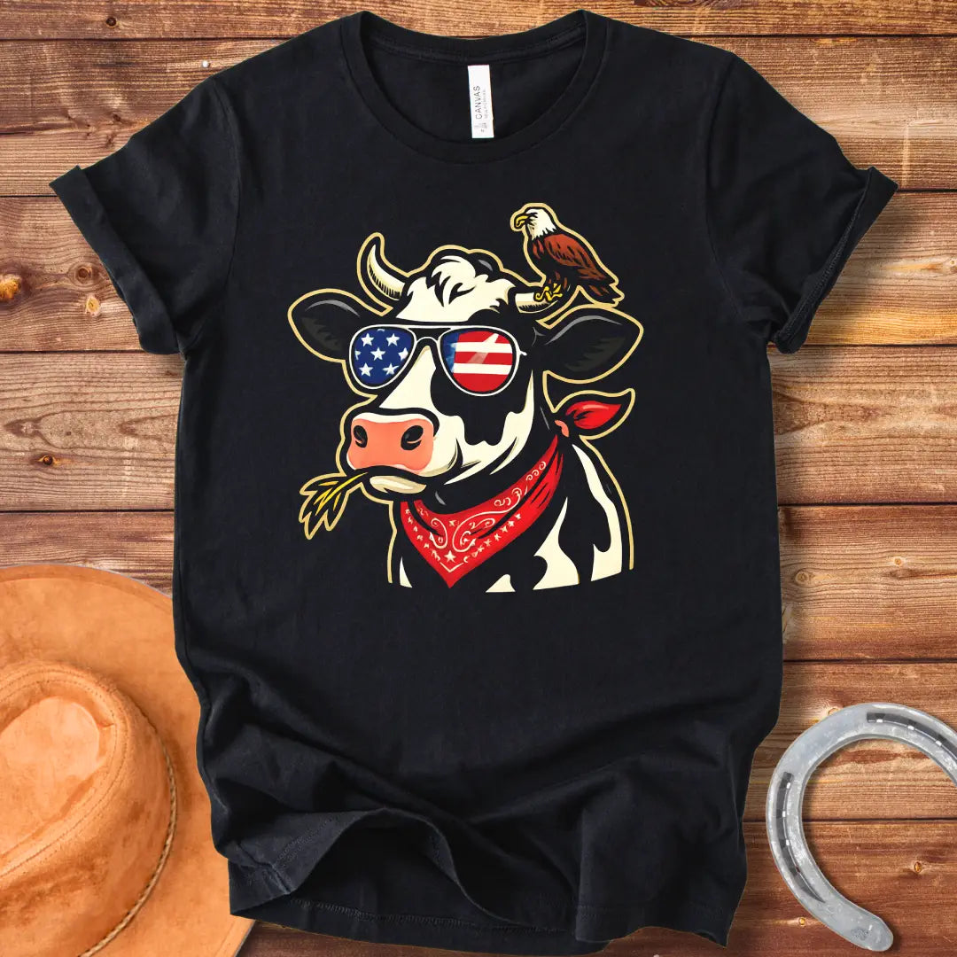 Patriotic cow wearing sunglasses with American flag design and an eagle on its head, a red bandana, and a wheat in its mouth, 'MERICA Moo T-Shirt'