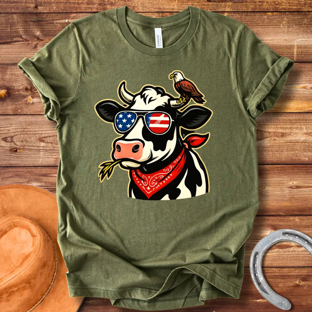 Patriotic cow wearing sunglasses with American flag design and an eagle on its head, a red bandana, and a wheat in its mouth, 'MERICA Moo T-Shirt'