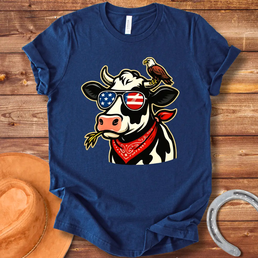 Patriotic cow wearing sunglasses with American flag design and an eagle on its head, a red bandana, and a wheat in its mouth, 'MERICA Moo T-Shirt'