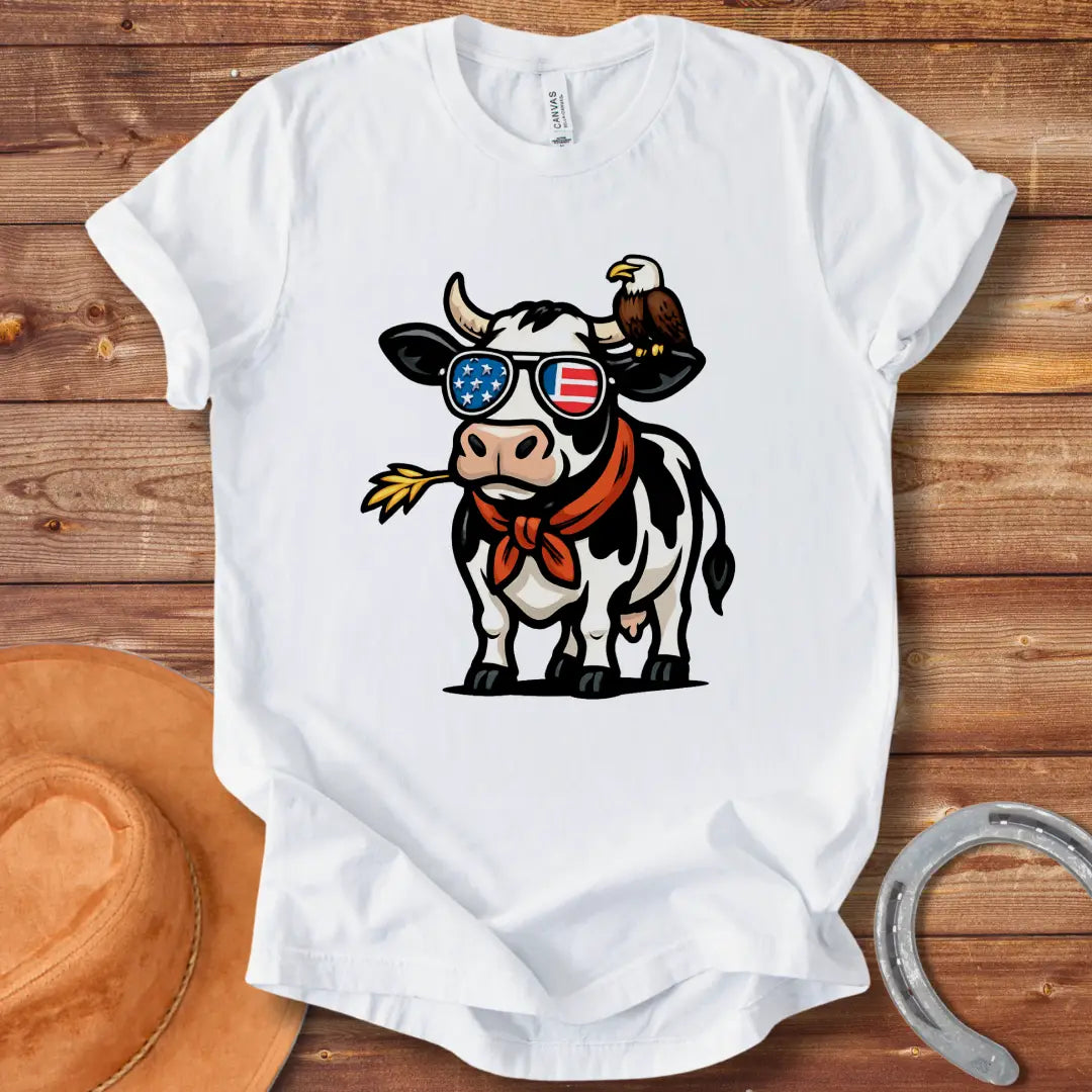 Patriotic cow wearing sunglasses with American flag design and an eagle on its head, a red bandana, and a wheat in its mouth, 'MERICA Moo T-Shirt'