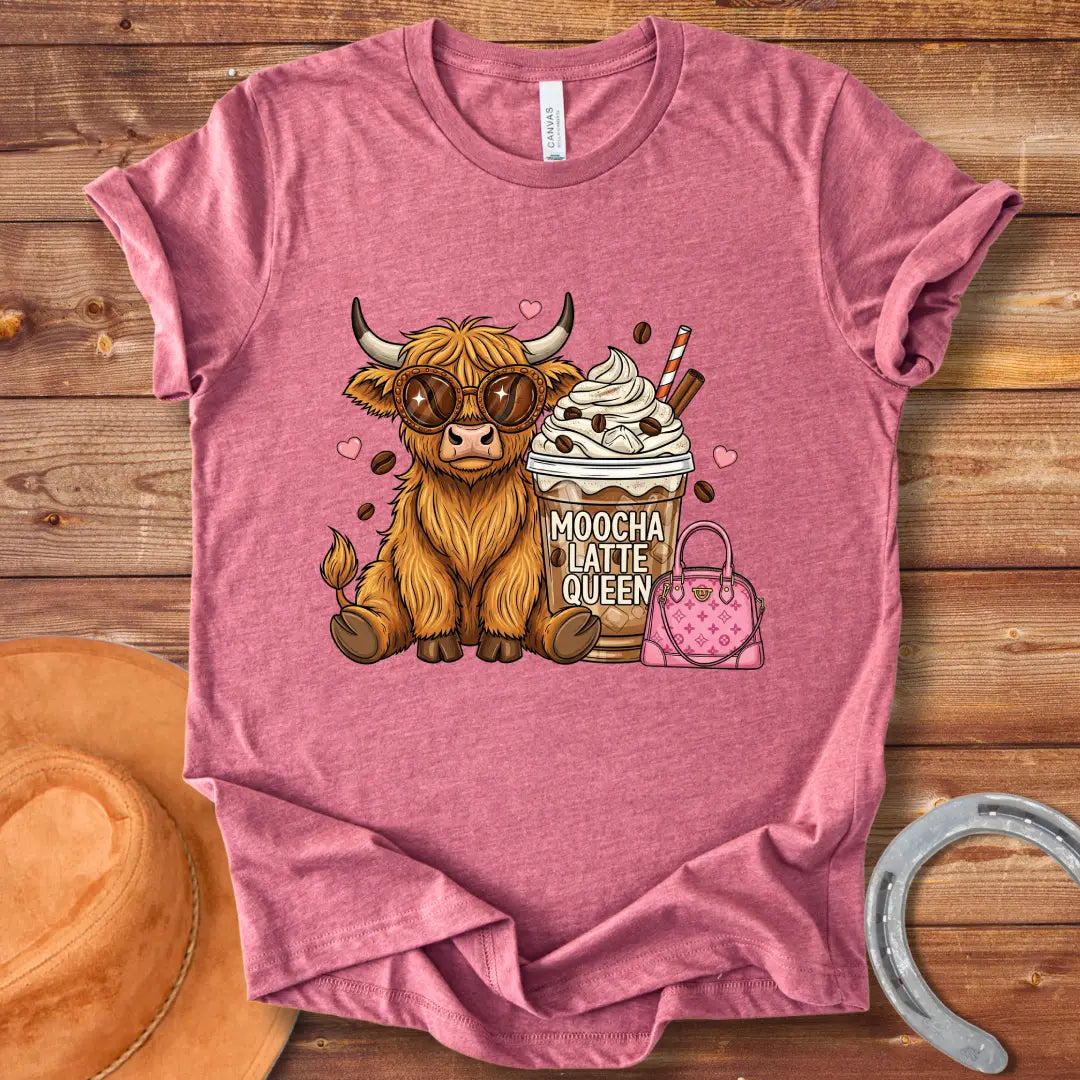 A cartoon image of a cute Highland cow wearing sunglasses, sitting next to a mocha latte and a pink purse that says 'Moocha Latte Queen' on it.