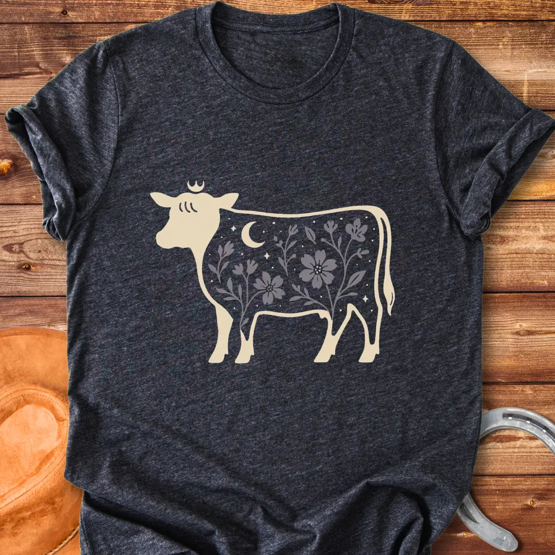 Silhouette of a Highland cow with a crown, moon, stars, and floral design, a dark aesthetic.