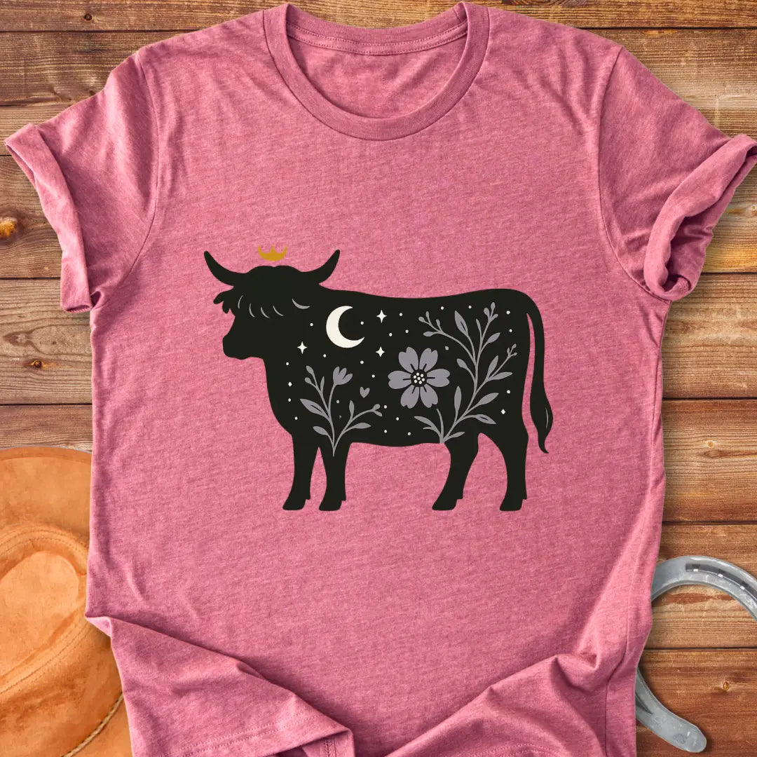 Silhouette of a Highland cow with a crown, moon, stars, and floral design, a dark aesthetic.