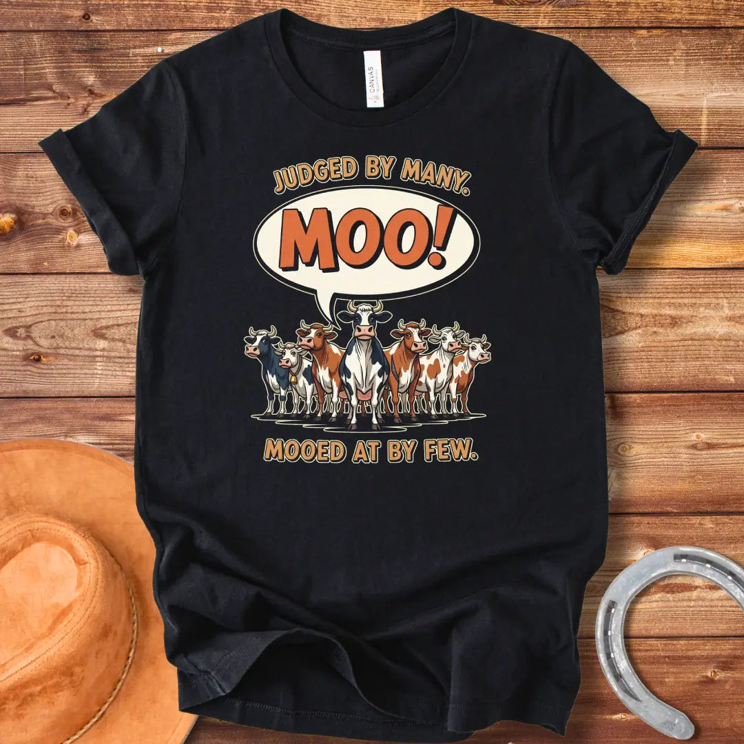 Moo-ed At By Few T-shirt featuring a group of cartoon cows with a speech bubble saying 'Moo!'