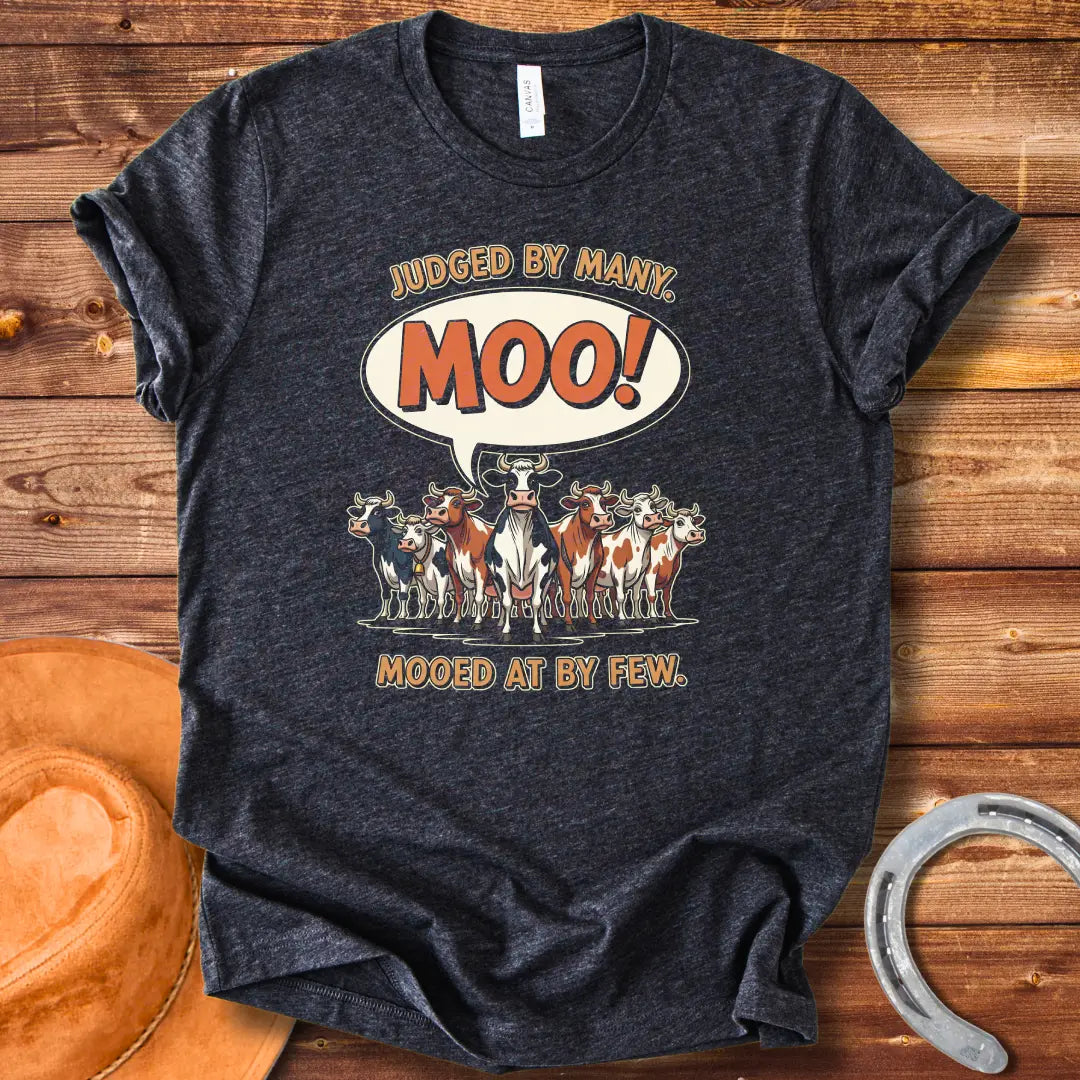 Moo-ed At By Few T-shirt featuring a group of cartoon cows with a speech bubble saying 'Moo!'