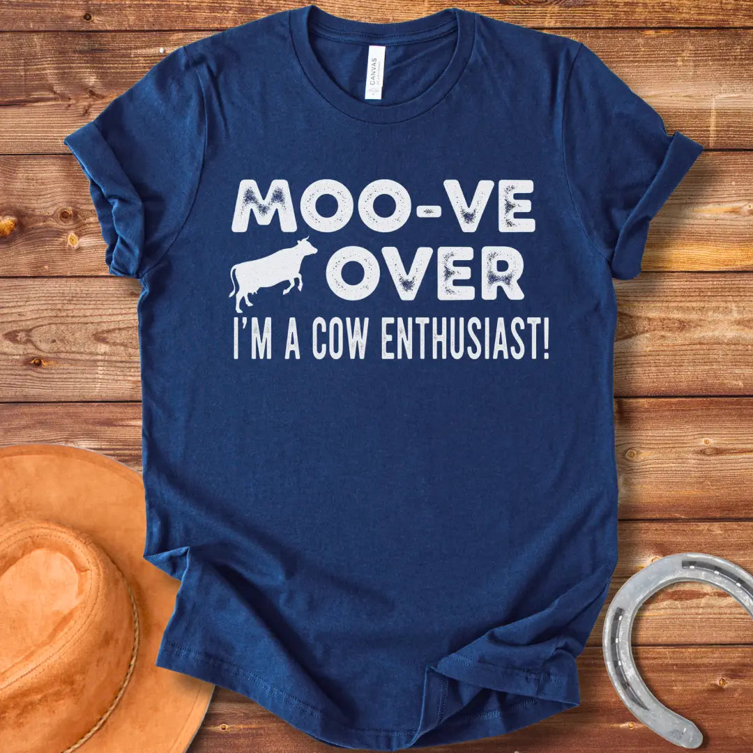 A black and white graphic tee design that says 'Moo-ve Over' with a silhouette of a cow and 'I'm a Cow Enthusiast!' below.