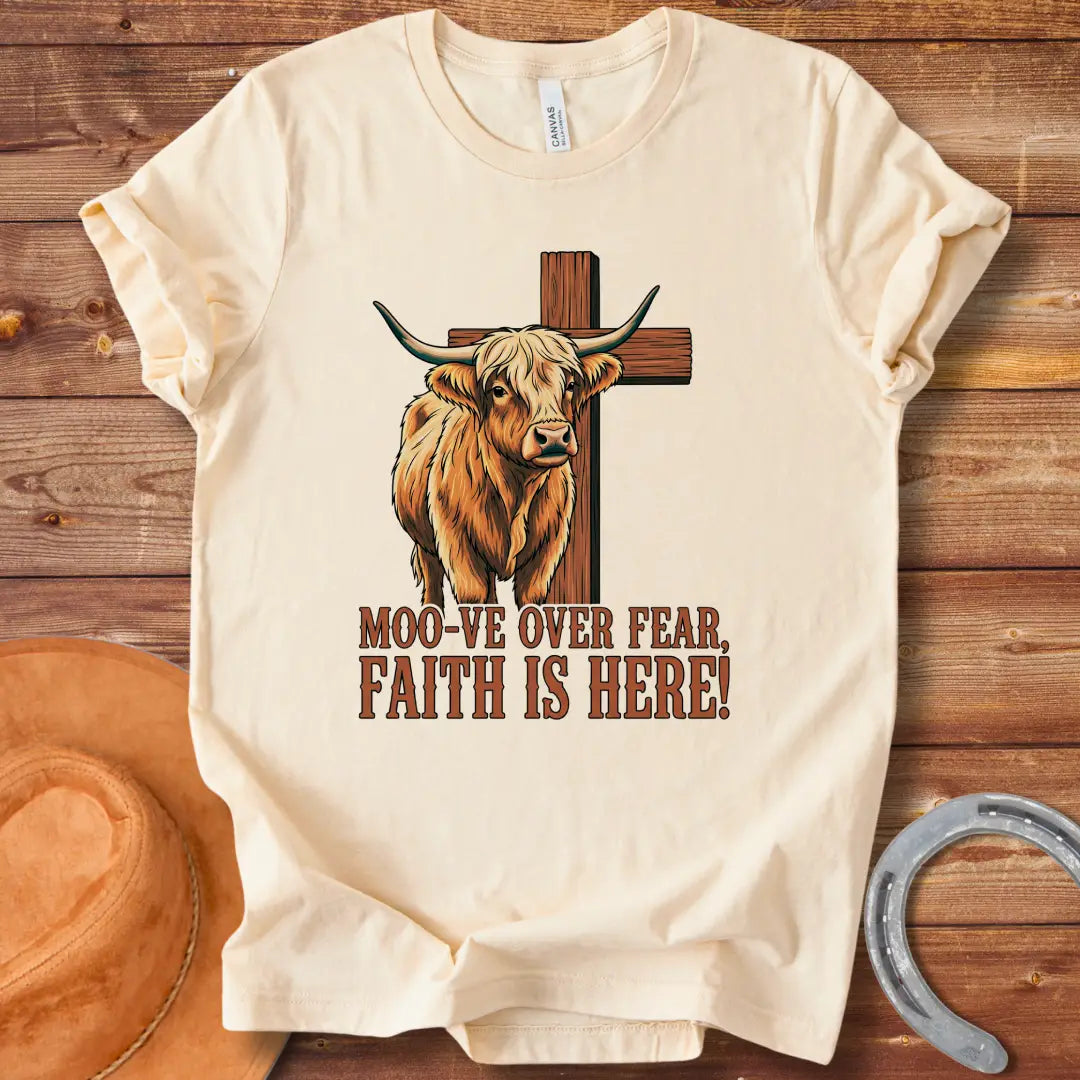 Cow standing in front of a wooden cross with the text 'Moo-ve Over Fear, Faith Is Here!'