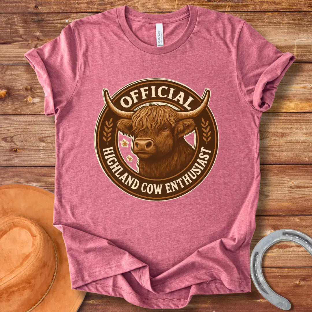 Official Highland Cow Enthusiast T-Shirt design featuring a detailed illustration of a Highland cow's head within a circular emblem with the words 'Official Highland Cow Enthusiast' written on it.