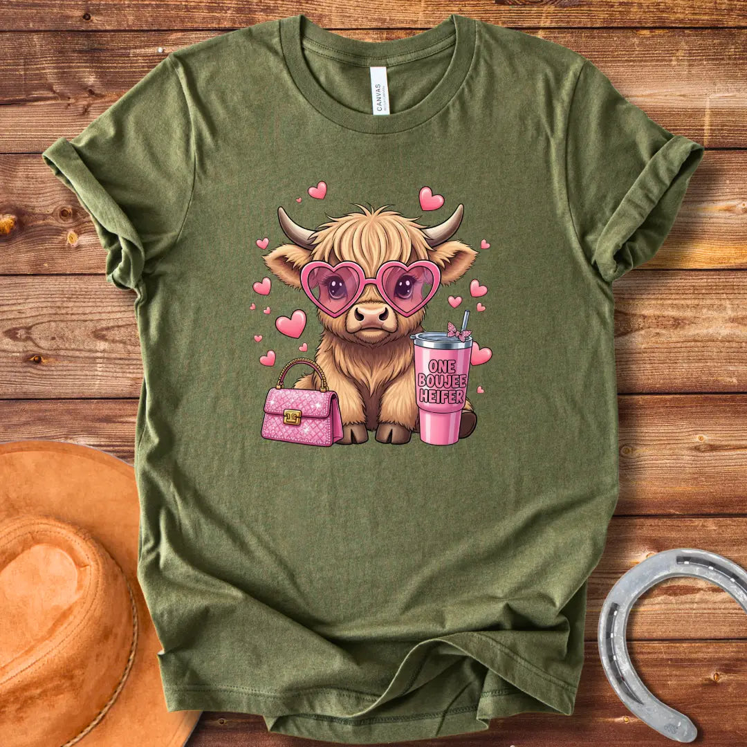 Illustration of a fluffy cow wearing heart-shaped sunglasses and holding a pink drink and purse that says 'One Boujee Heifer' with pink hearts surrounding it.