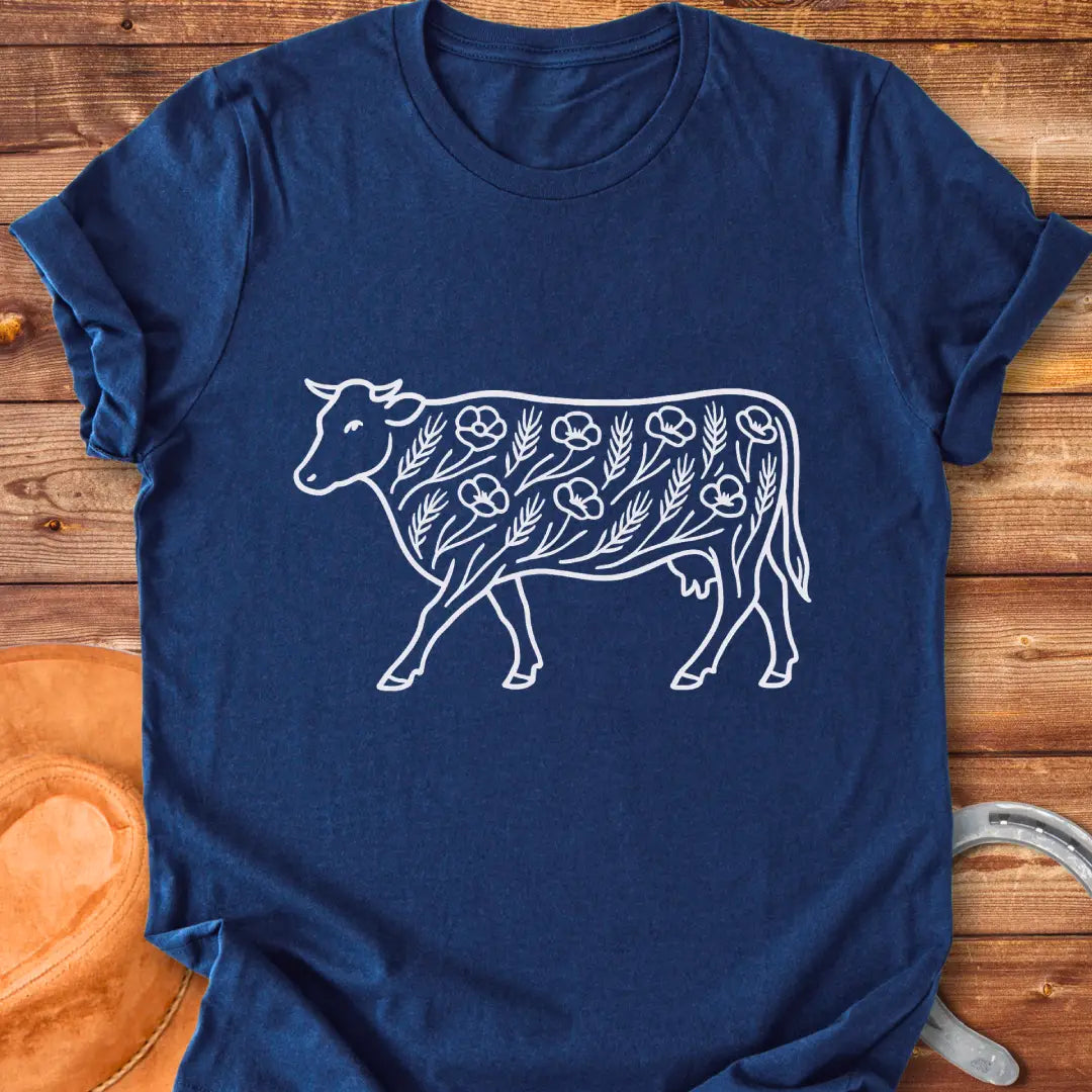 Line art illustration of a cow adorned with poppies and wheat stalks, representing a countryside theme.