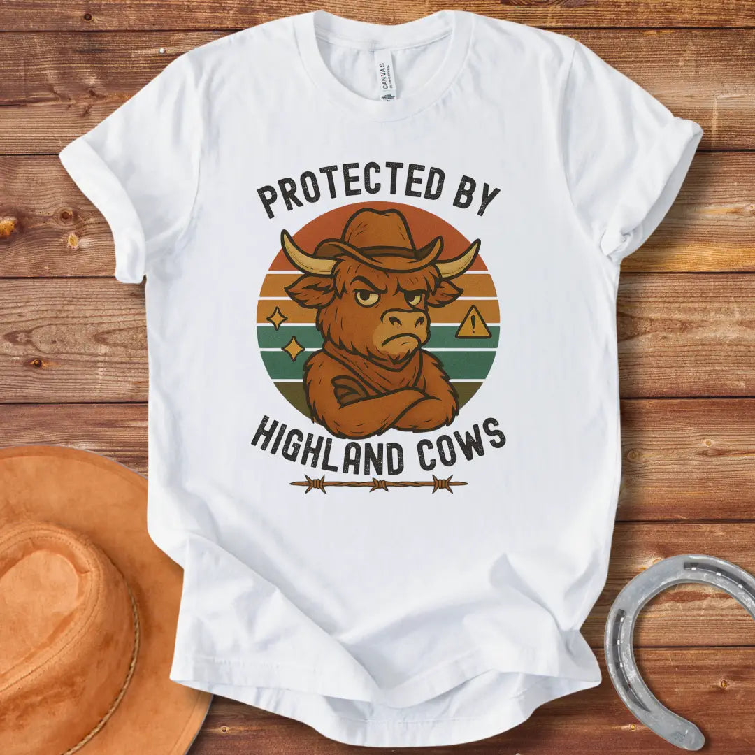 Protected by Highland Cows t-shirt featuring a cartoon Highland cow wearing a cowboy hat with a stern look.