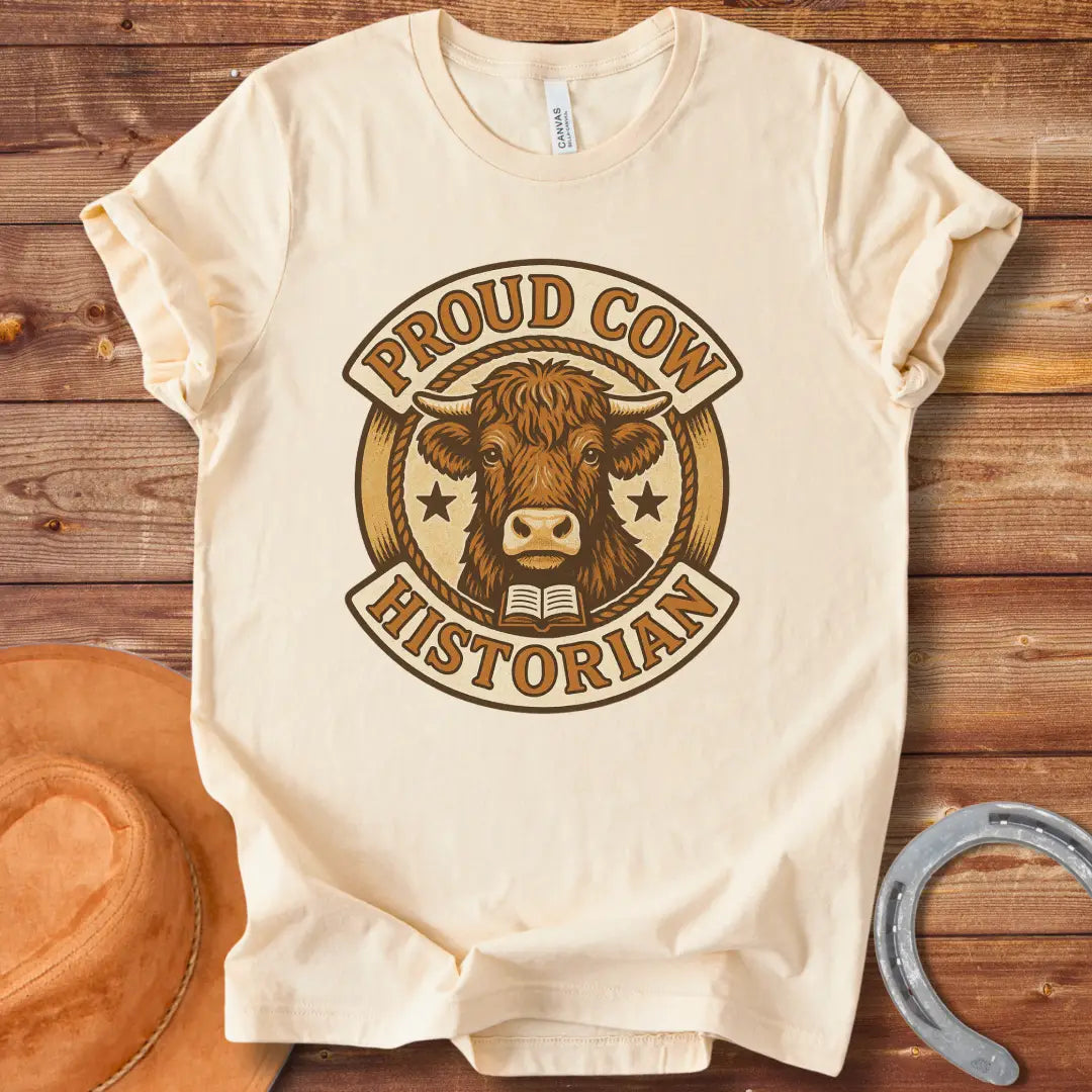 Proud Cow Historian T-Shirt featuring a highland cow, books, and stars.