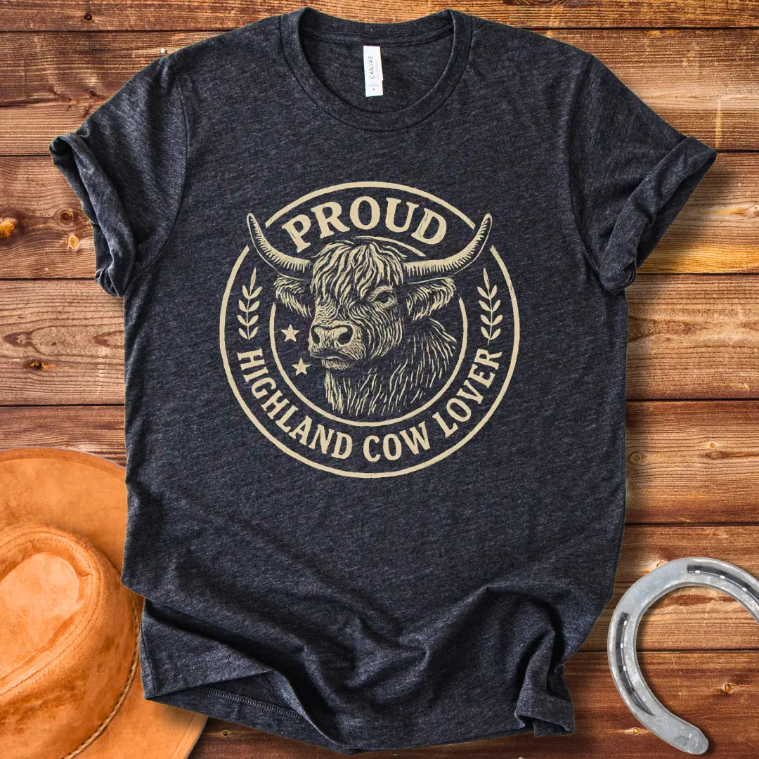 Proud Highland Cow Lover T-Shirt featuring a detailed illustration of a Highland cow's head and the text 'Proud Highland Cow Lover' in a circular design.