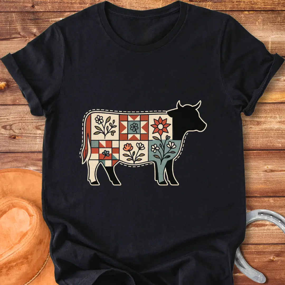 Quilt Blooms T-Shirt featuring a cow silhouette with a patchwork quilt pattern and floral details.