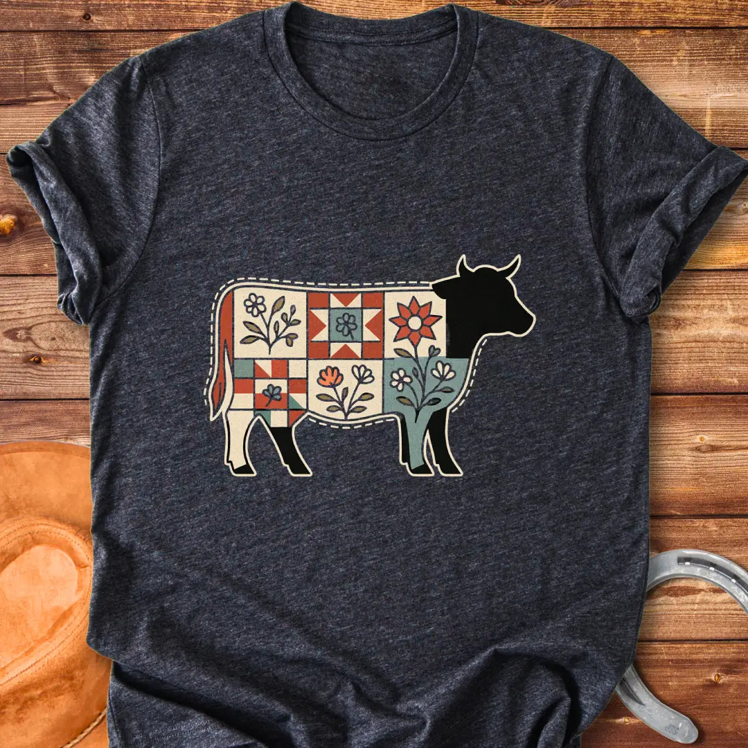 Quilt Blooms T-Shirt featuring a cow silhouette with a patchwork quilt pattern and floral details.