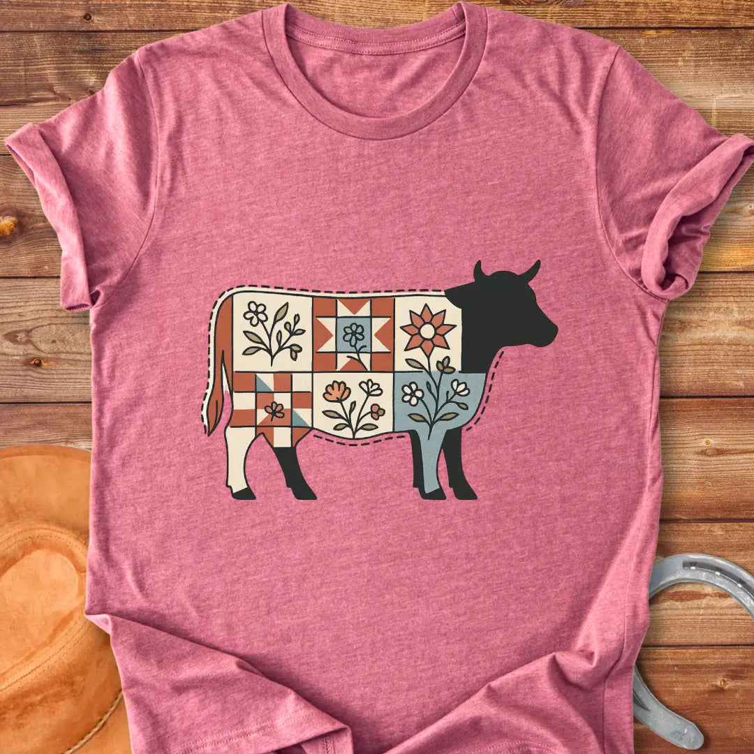 Quilt Blooms T-Shirt featuring a cow silhouette with a patchwork quilt pattern and floral details.